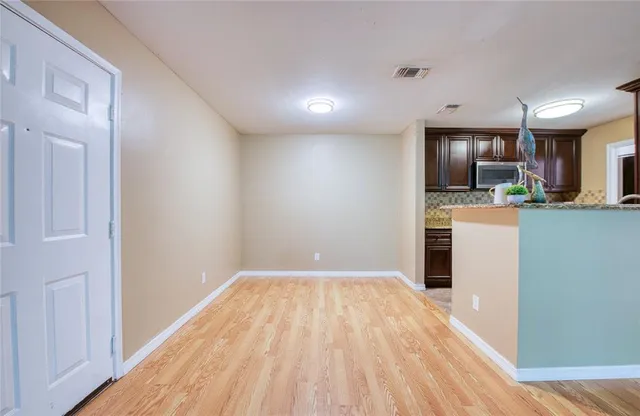 a view of a kitchen with wooden floor