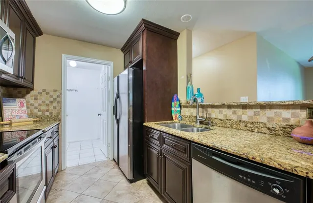 a kitchen with a sink and a refrigerator
