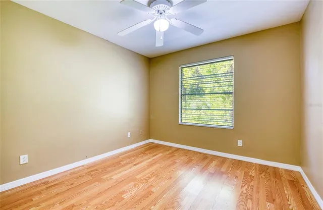 a view of a room with wooden floor and a bathroom