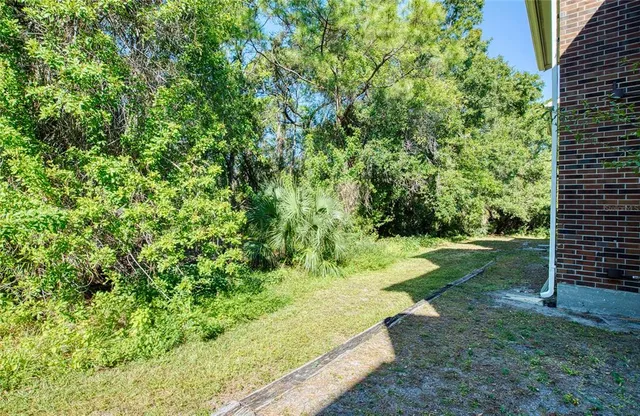 an aerial view of a house with garden space and street view