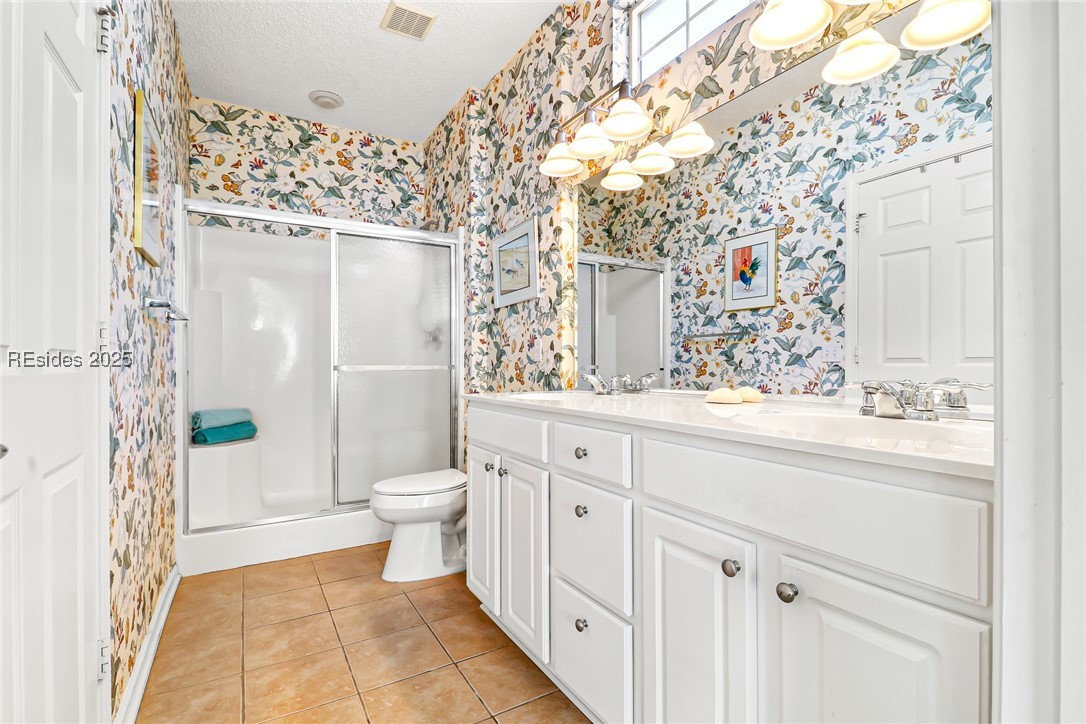 153 Landing Lane Bluffton, SC 29909 - Photo 18 of 31 Ensuite bathroom with roomy shower, dual vanity sink, and access to the spacious walk-in closet.