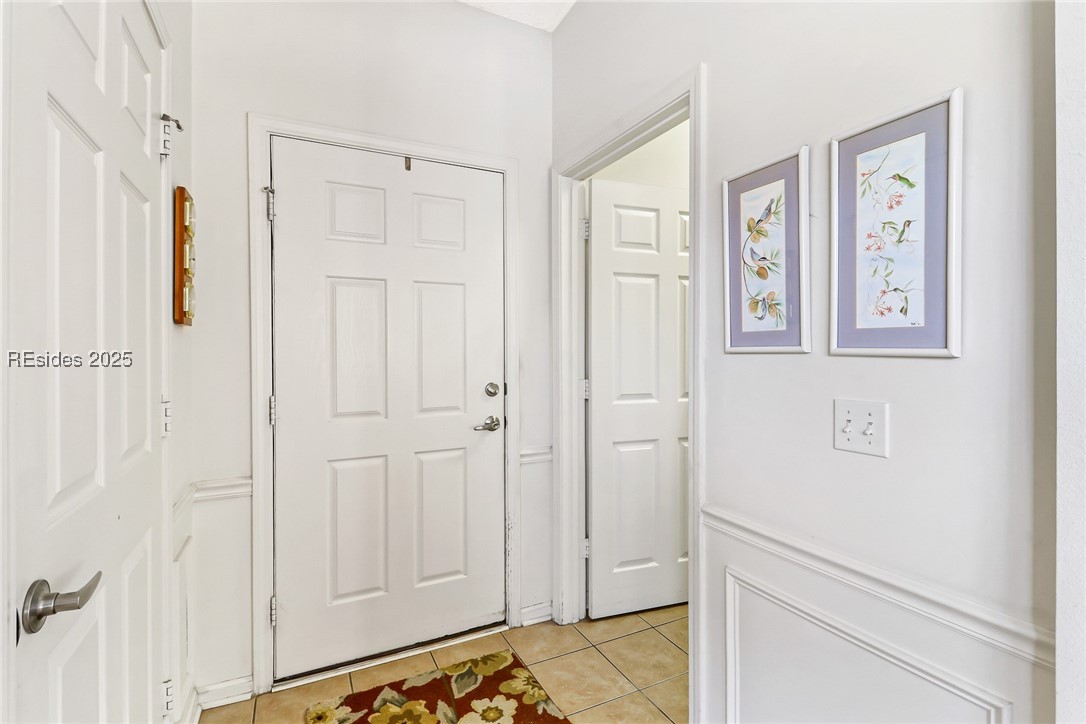 153 Landing Lane Bluffton, SC 29909 - Photo 21 of 31 Front door, generous closet on the left and access to the laundry/utility room and garage on the right.