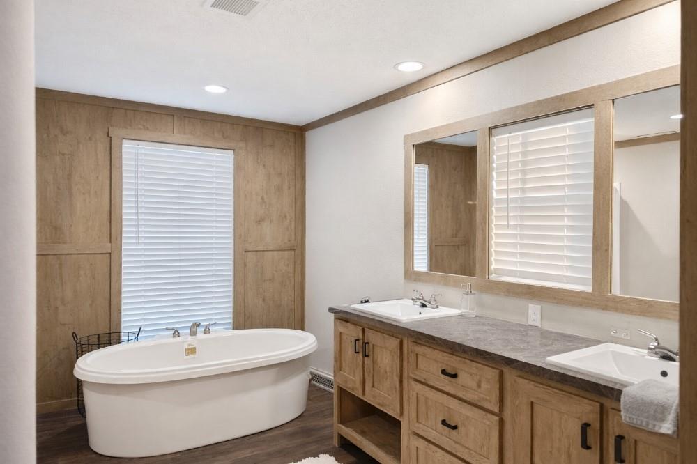 4504 Bethany Road Sherman, TX 75090 - Photo 9 of 20 a bathroom with a granite countertop sink and a bathtub