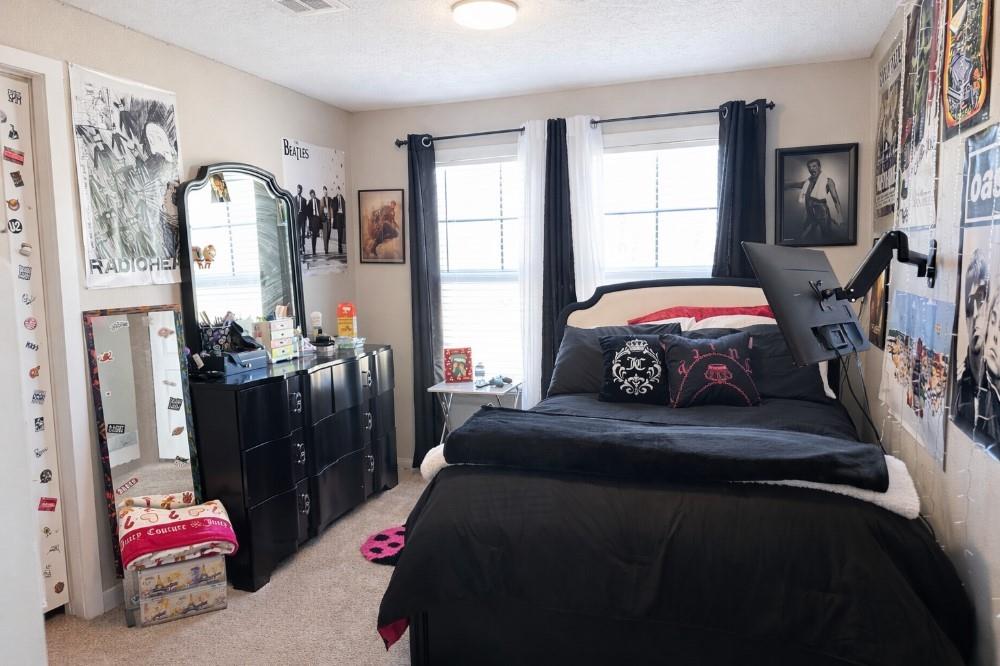 4504 Bethany Road Sherman, TX 75090 - Photo 10 of 20 a bedroom with a bed dresser and a window
