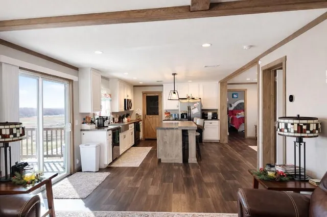 a large kitchen with lots of counter space a sink appliances and a dining table