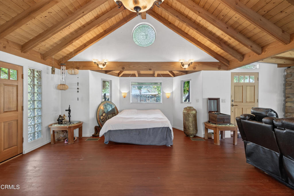 8416 Wheeler Canyon Road Santa Paula, CA 93060 - Photo 16 of 48 a bedroom with furniture and wooden floor