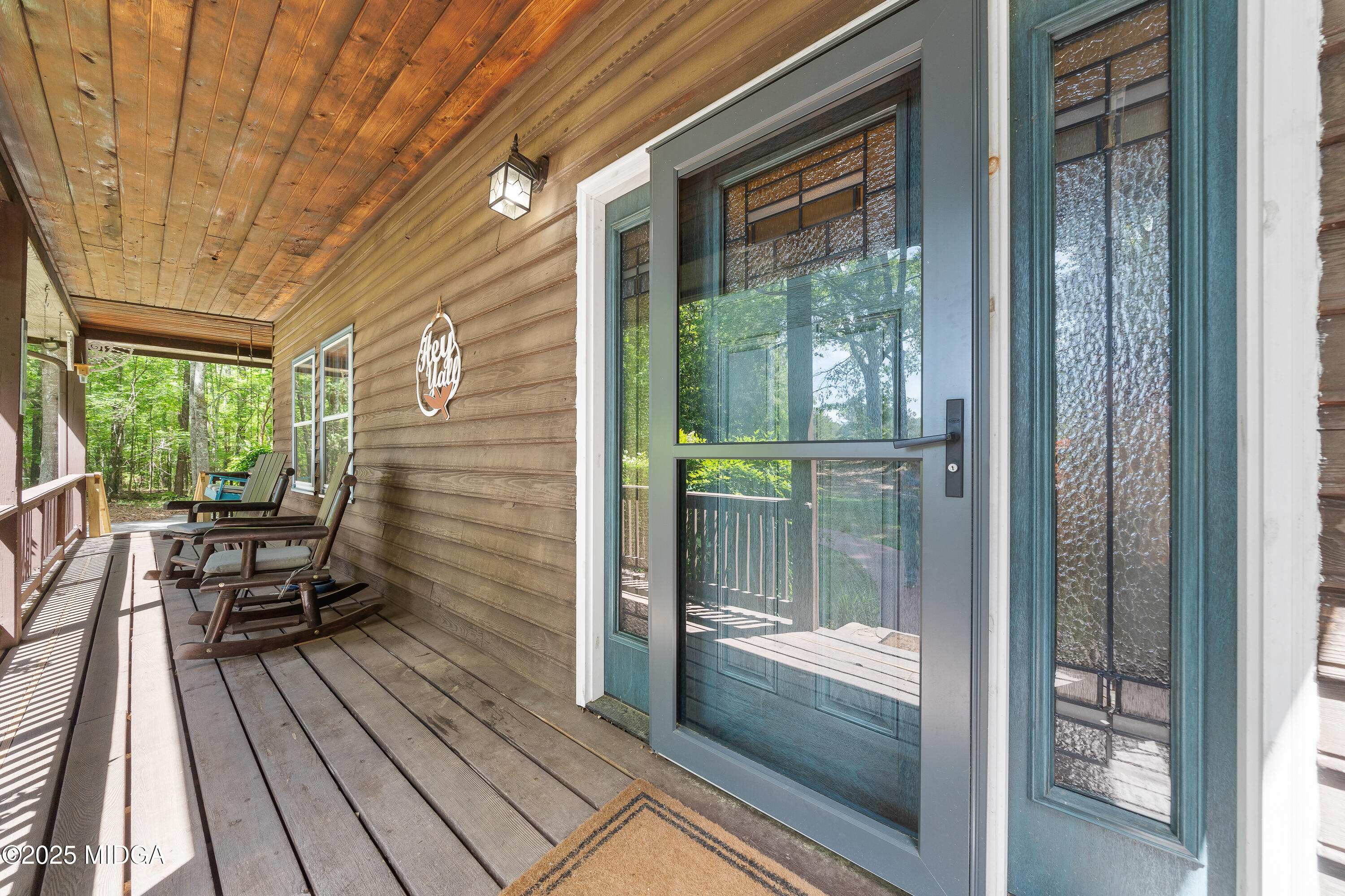 1627 Leguin Mill Road Locust Grove, GA 30248 - Photo 18 of 49 a balcony with chairs and wooden floor