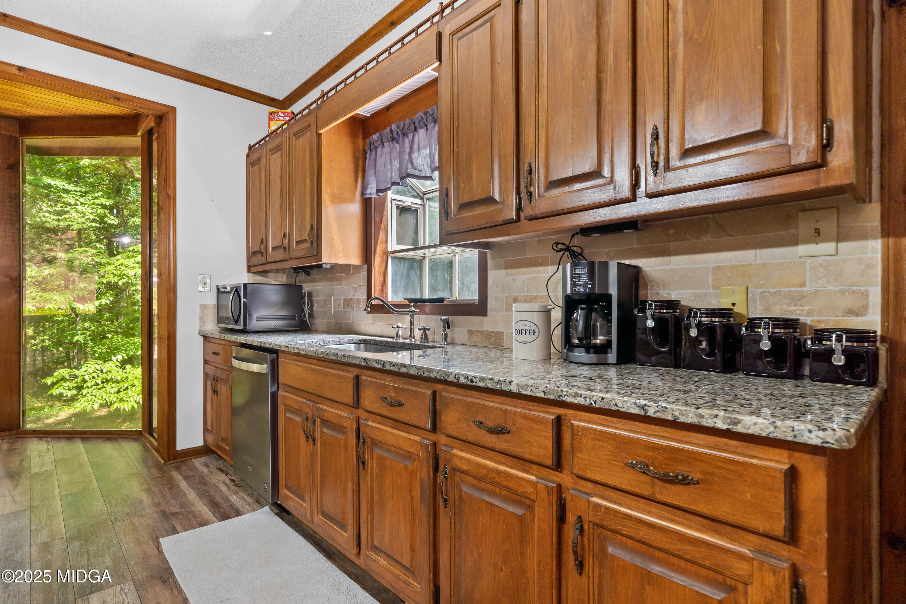 1627 Leguin Mill Road Locust Grove, GA 30248 - Photo 24 of 49 a kitchen with stainless steel appliances granite countertop a sink a stove and cabinets