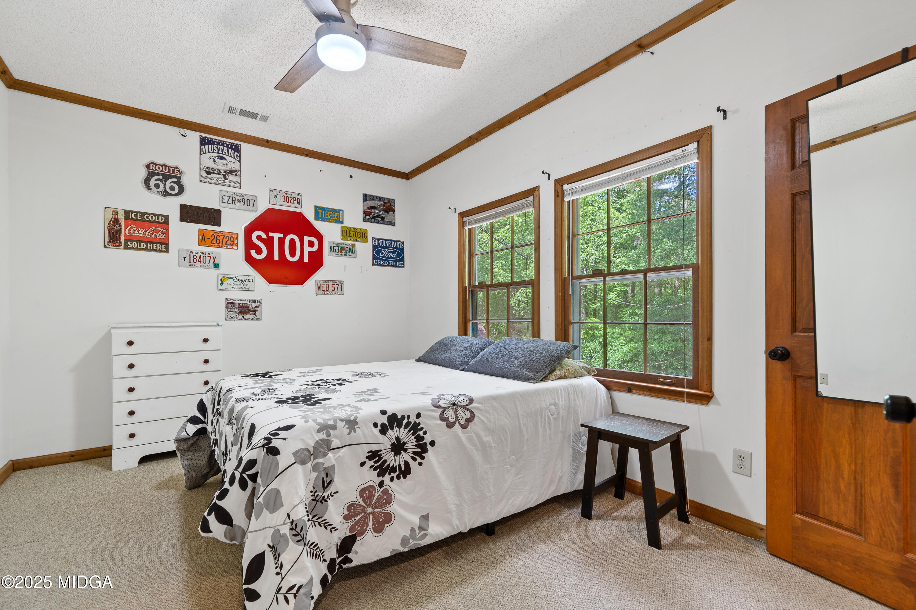 1627 Leguin Mill Road Locust Grove, GA 30248 - Photo 32 of 49 a bedroom with a bed and a window