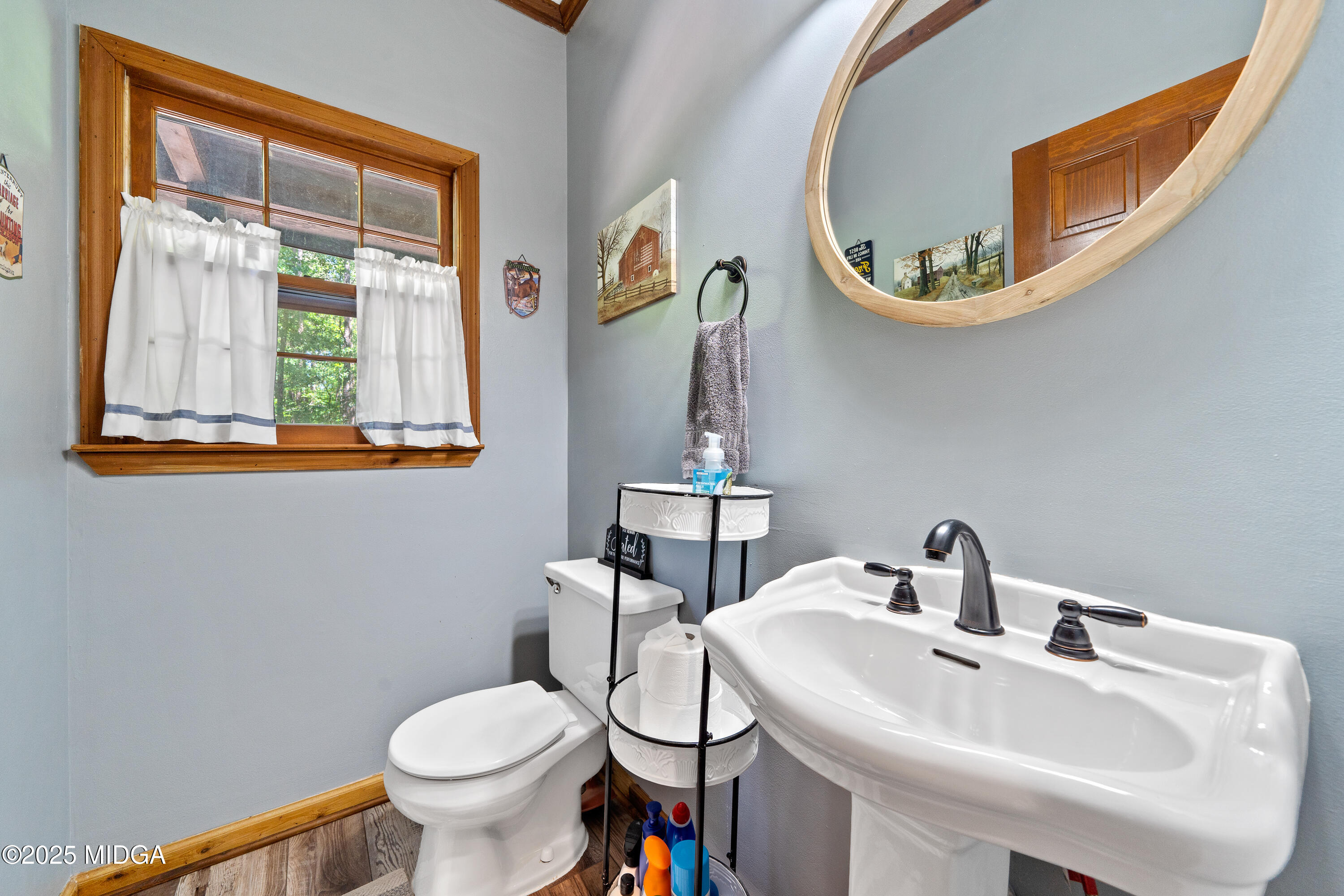 1627 Leguin Mill Road Locust Grove, GA 30248 - Photo 39 of 49 a bathroom with a toilet sink and mirror