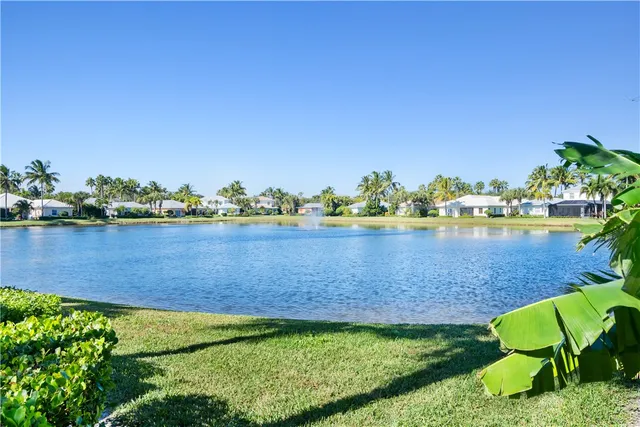 a view of a house with a swimming pool and sitting area
