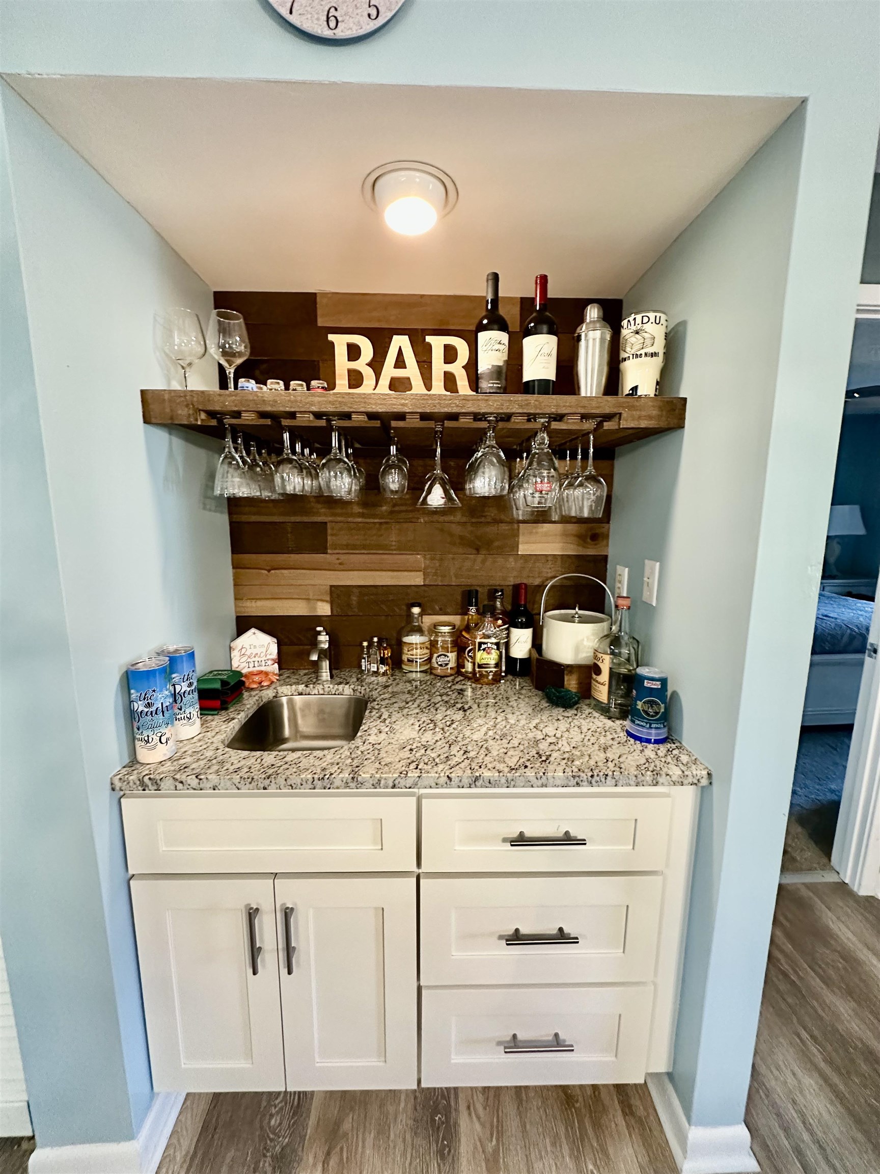 501 Maison Drive, Unit C9 Myrtle Beach, SC 29572 - Photo 19 of 27 Indoor wet bar featuring open shelves, white cabinetry, light stone counters, and light wood-style flooring