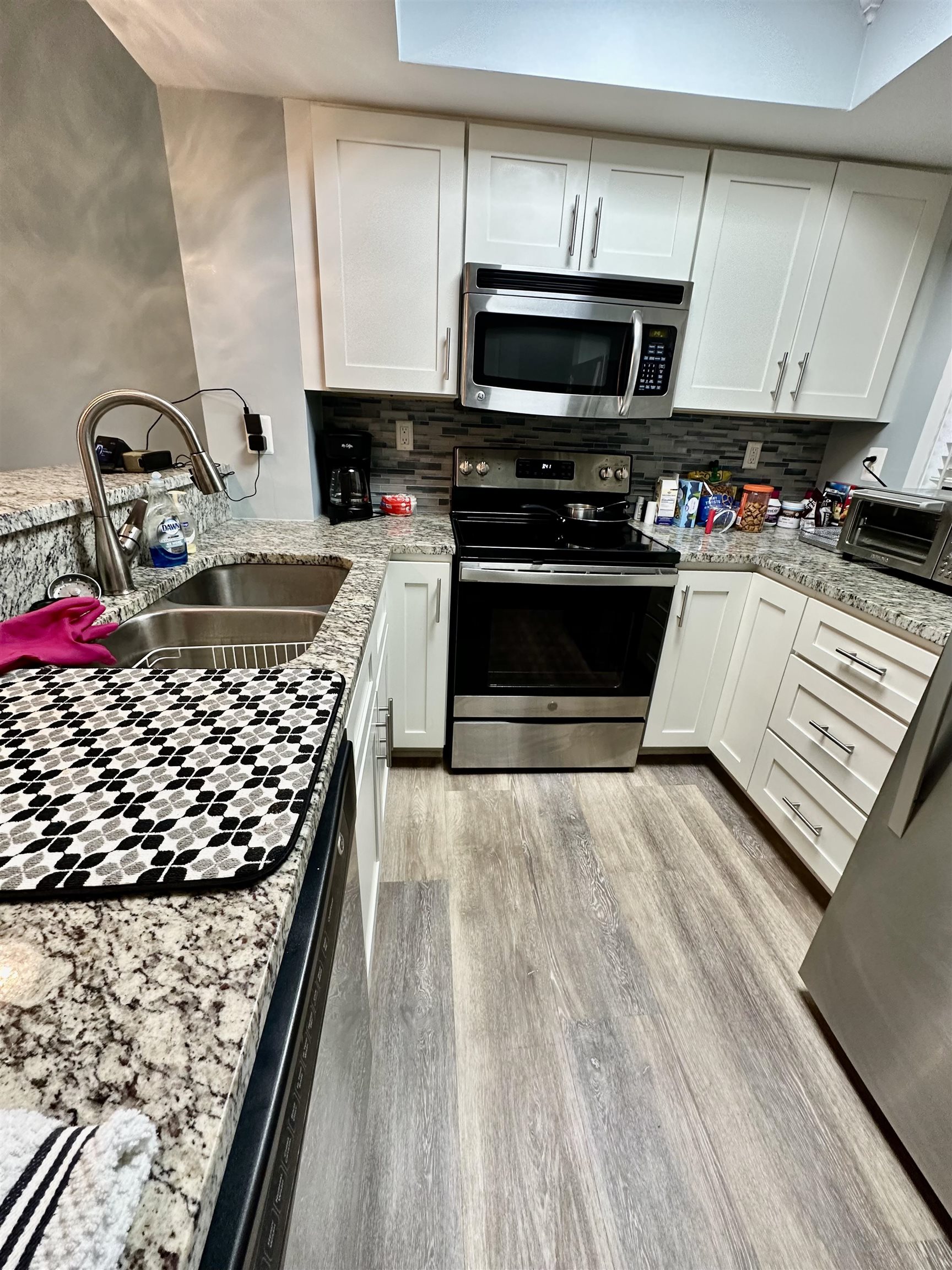 501 Maison Drive, Unit C9 Myrtle Beach, SC 29572 - Photo 20 of 27 Kitchen featuring white cabinets, appliances with stainless steel finishes, and light stone counters