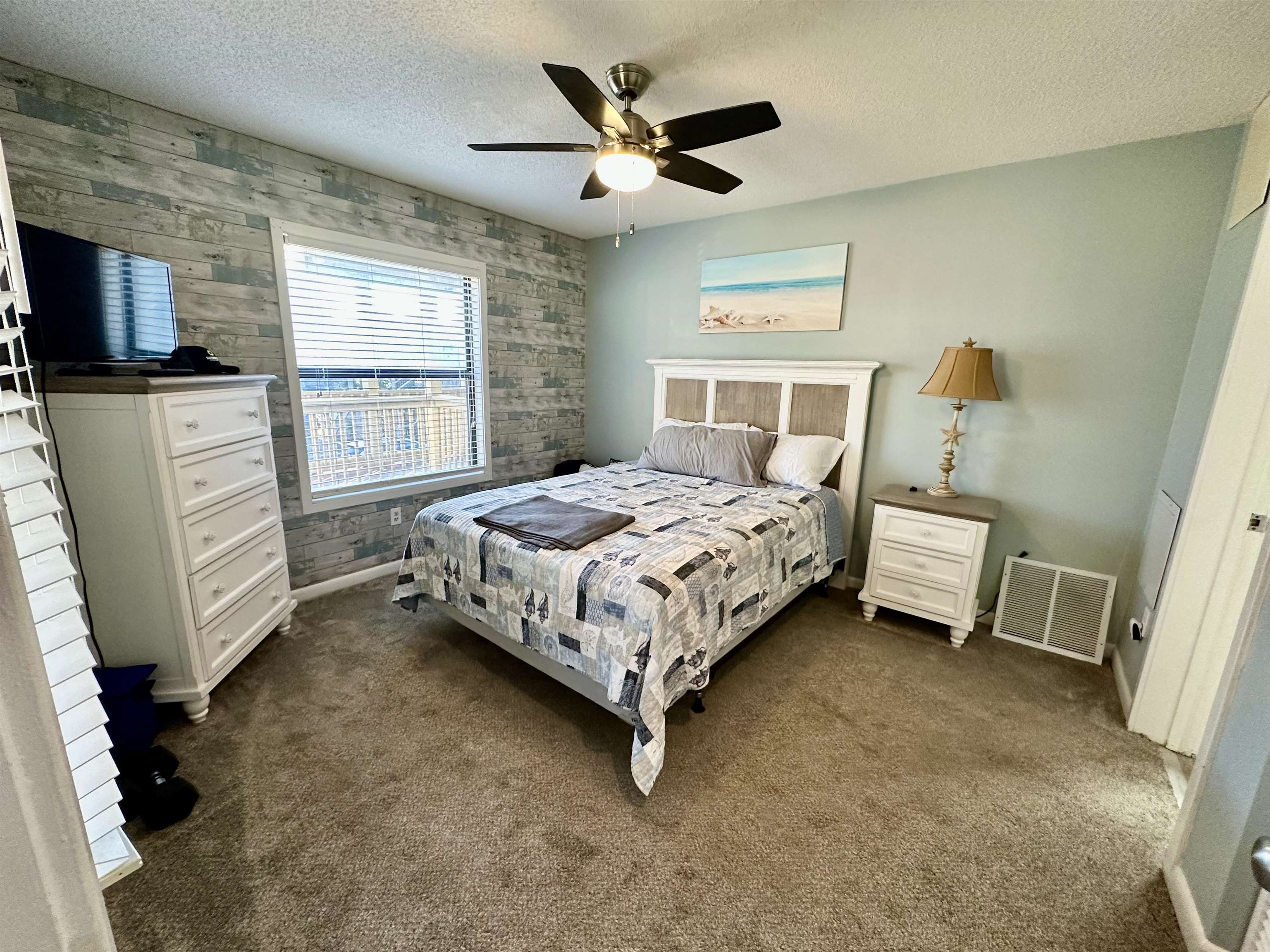 501 Maison Drive, Unit C9 Myrtle Beach, SC 29572 - Photo 10 of 27 Bedroom featuring carpet floors, a textured ceiling, ceiling fan, and an accent wall