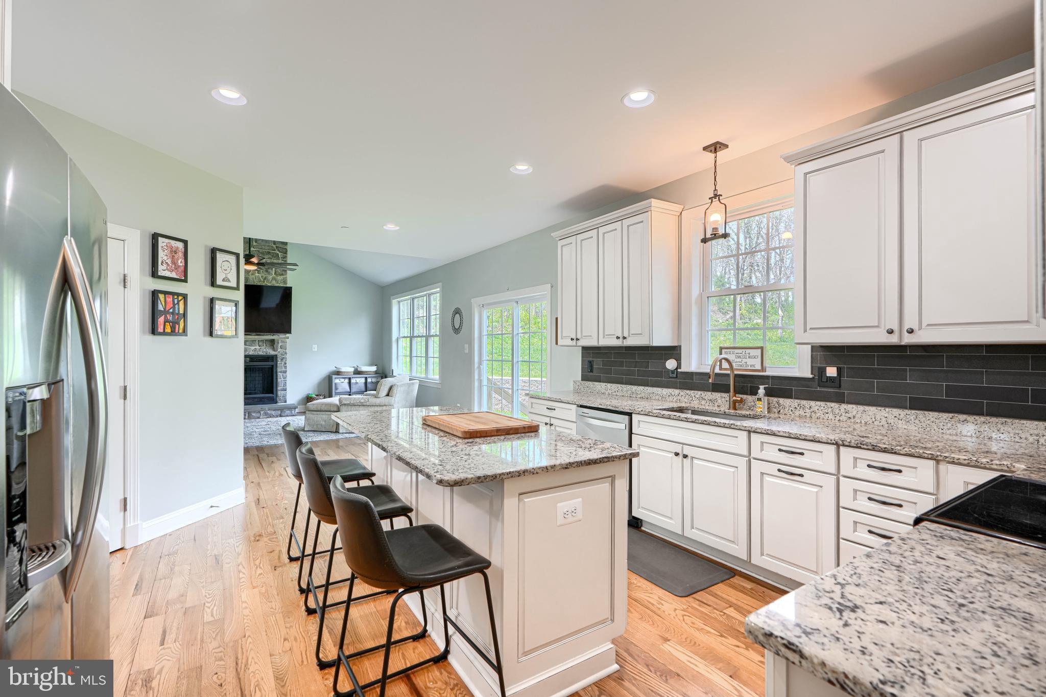 13012 Liberty Road Union Bridge, MD 21791 - Photo 11 of 47 a kitchen with stainless steel appliances granite countertop a table chairs sink and cabinets