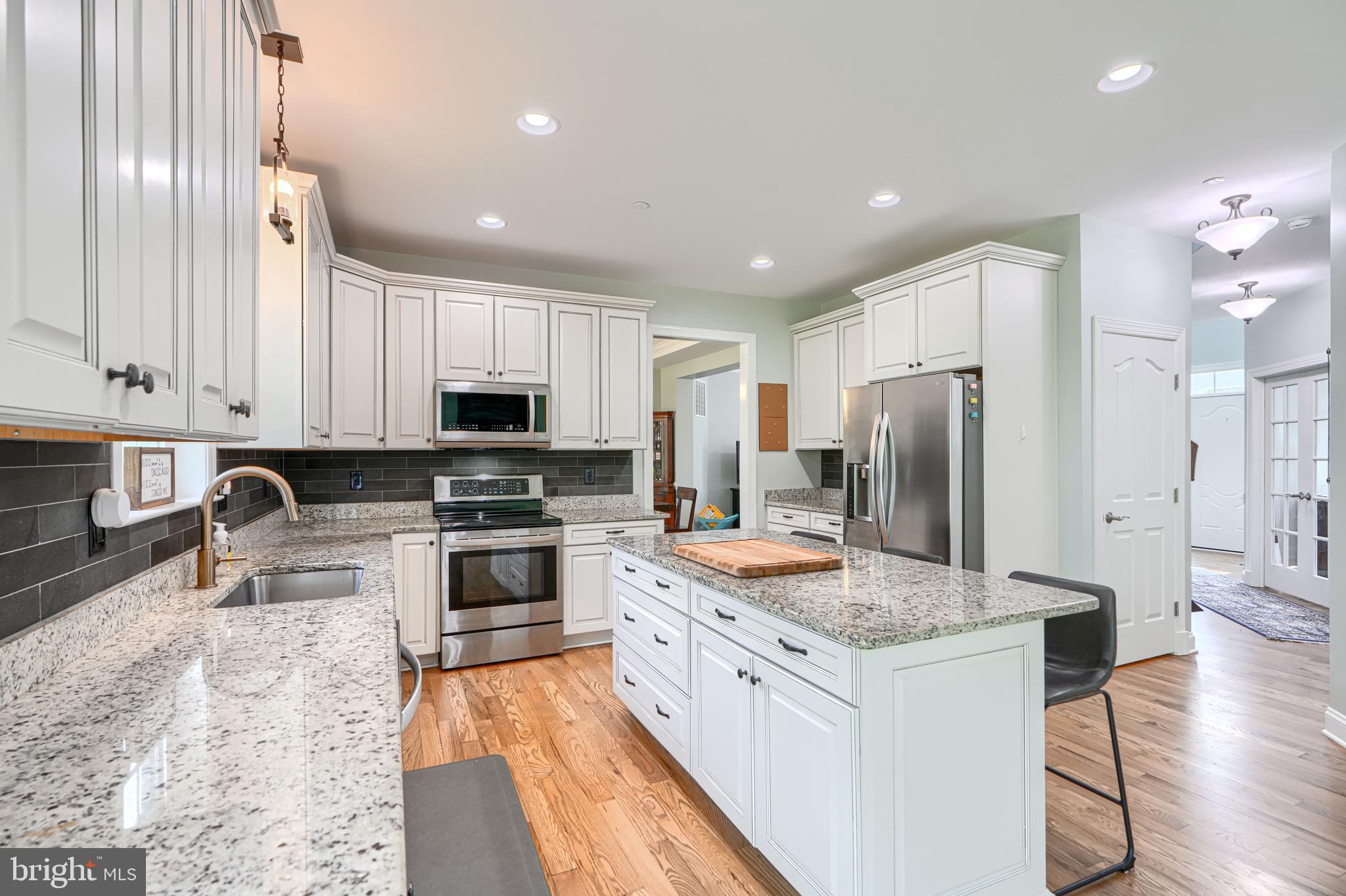 13012 Liberty Road Union Bridge, MD 21791 - Photo 12 of 47 a kitchen with stainless steel appliances granite countertop a refrigerator stove microwave and sink