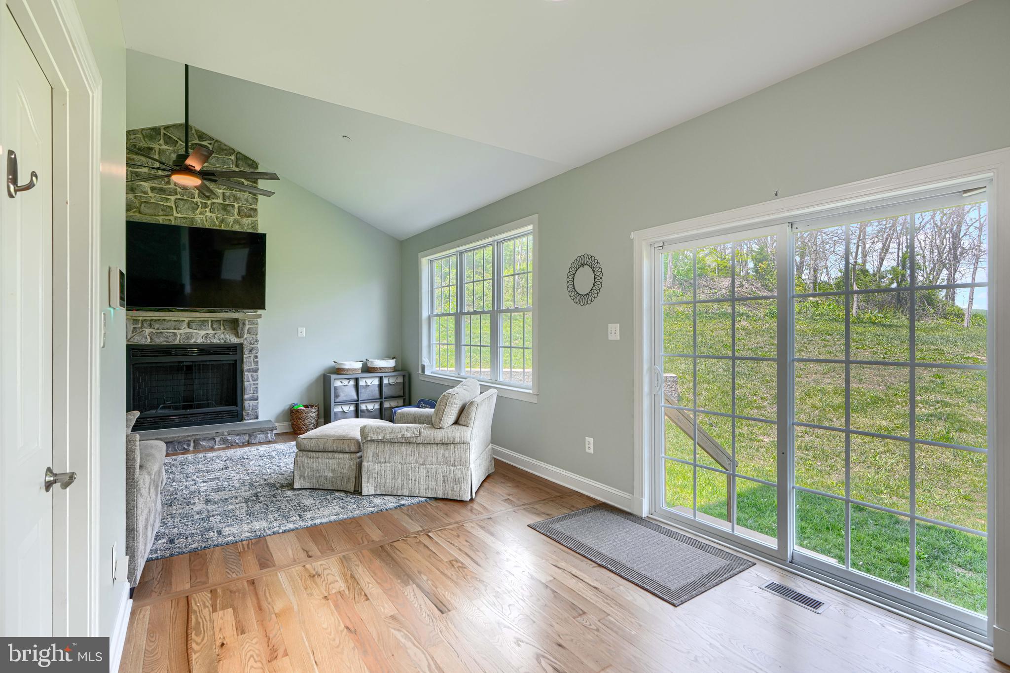 13012 Liberty Road Union Bridge, MD 21791 - Photo 15 of 47 a living room with furniture a flat screen tv and a fireplace