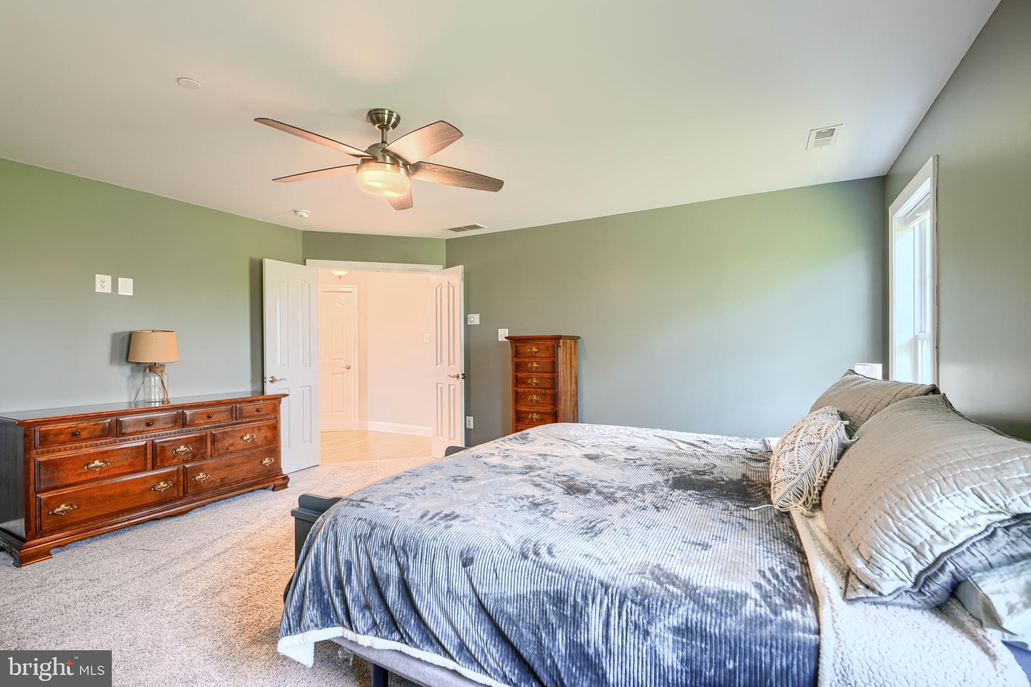 13012 Liberty Road Union Bridge, MD 21791 - Photo 24 of 47 a bedroom with a bed and a chandelier