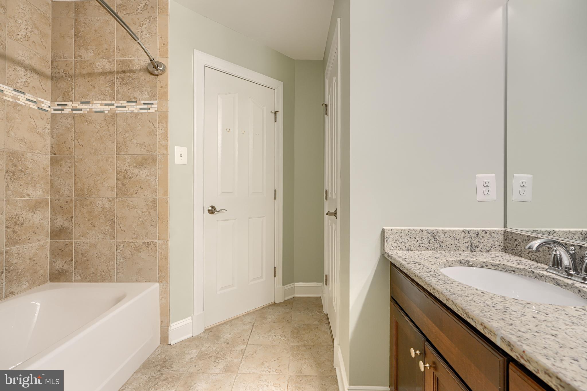 13012 Liberty Road Union Bridge, MD 21791 - Photo 35 of 47 a bathroom with a granite countertop bathtub shower sink and mirror