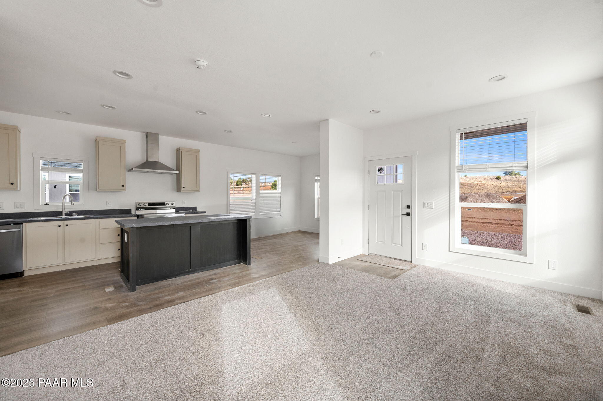 29 East Abra Road Paulden, AZ 86334 - Photo 6 of 22 a large white kitchen with kitchen island granite countertop a sink window and stainless steel appliances