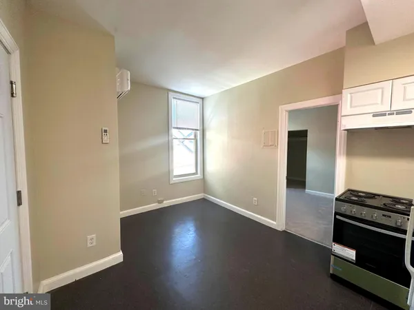 a view of kitchen and hallway with a stove