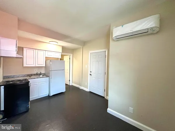 a kitchen with granite countertop cabinets and refrigerator