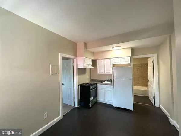 a view of a kitchen with a refrigerator a stove top oven and a refrigerator