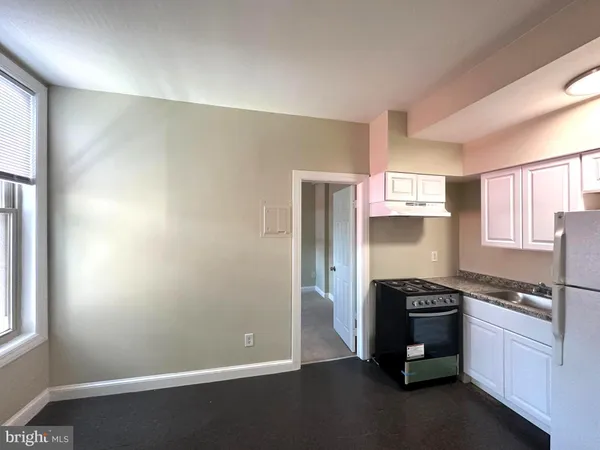 a kitchen with stainless steel appliances a stove and a refrigerator