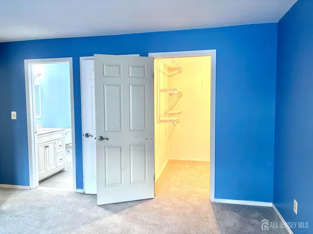 a bathroom with a granite countertop toilet and a sink