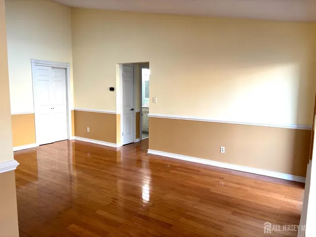 a view of an empty room and wooden floor