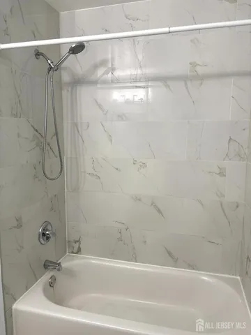 a bathroom with a shower and a shower