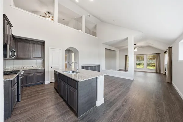 a kitchen with a sink and wooden cabinets