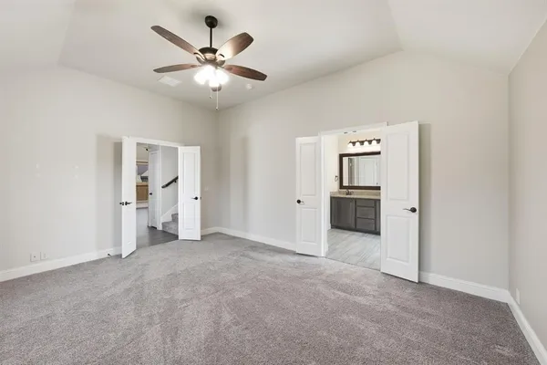 an empty room with closet and windows