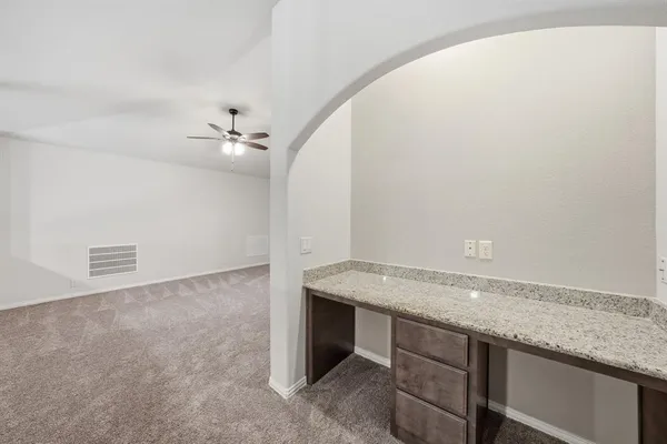 a view of a kitchen with a sink and cabinets