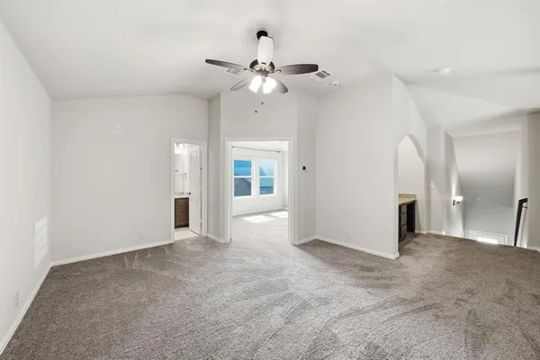 an empty room with fan and entrance