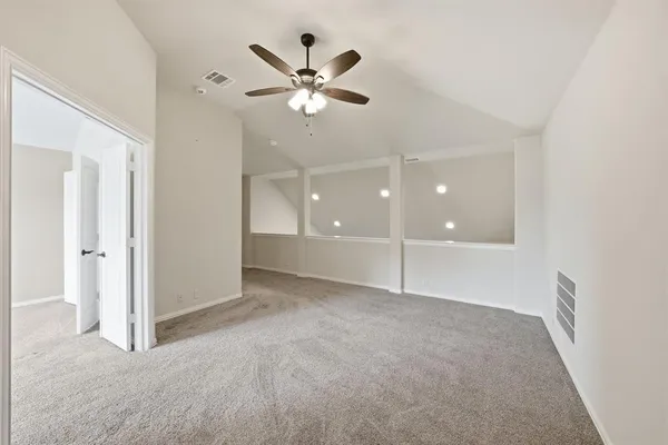 a view of a livingroom with a ceiling fan and window
