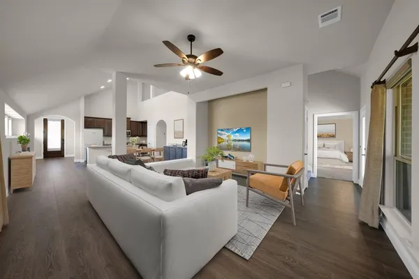 a living room with furniture and wooden floor