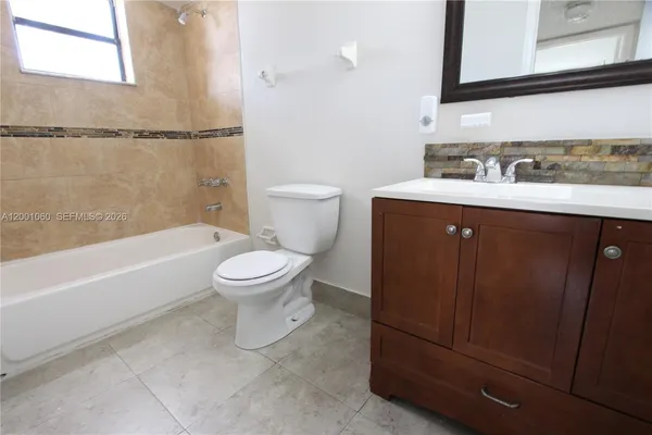 a bathroom with a sink a toilet and a bathtub