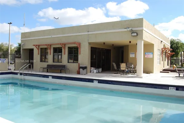 a view of a patio with swimming pool table and chairs