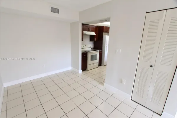 a view of a kitchen with an empty space and a stove top oven