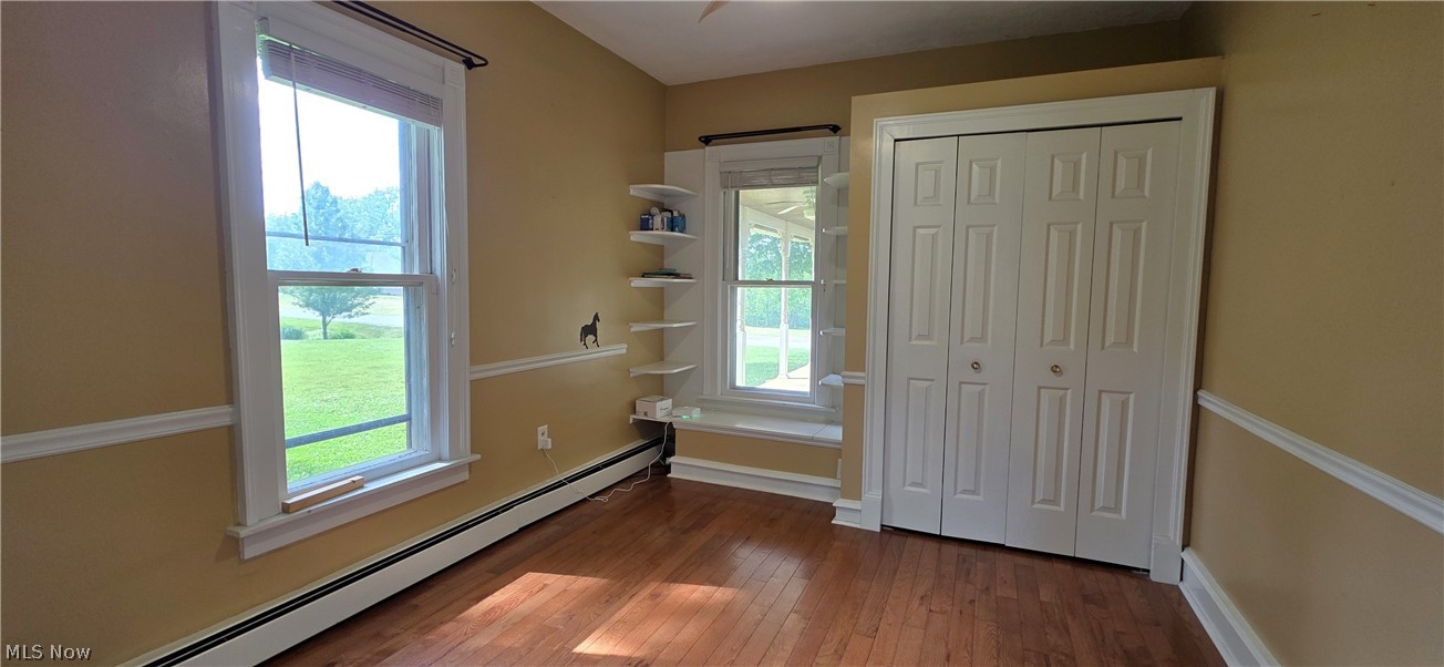 7414 Greenwich Road Seville, OH 44273 - Photo 13 of 50 Flexible first-floor room bedroom/ office with hardwood floors, beautiful woodwork, ceiling fan, window seat, and attached half bath.