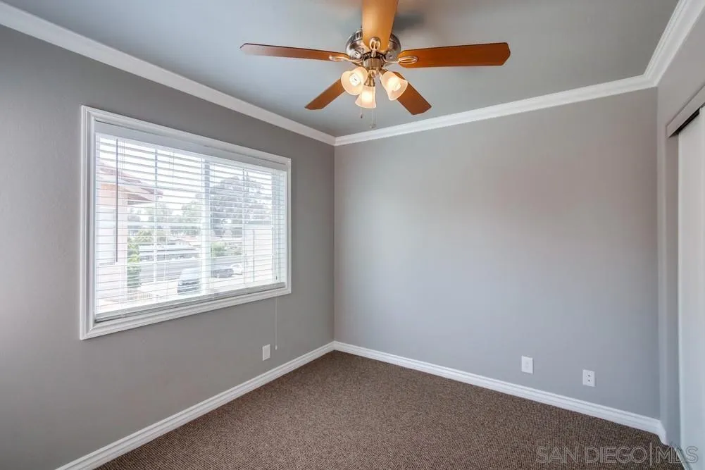 880 Friendly Circle El Cajon, CA 92021 - Photo 20 of 27 an empty room with windows and fan