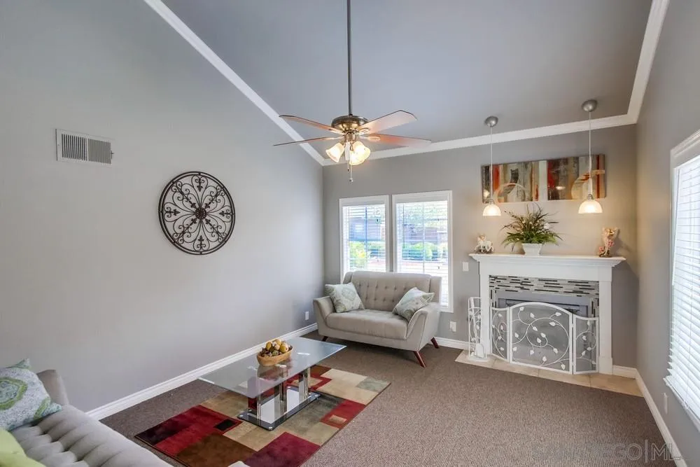 880 Friendly Circle El Cajon, CA 92021 - Photo 3 of 27 a living room with furniture a clock and a chandelier