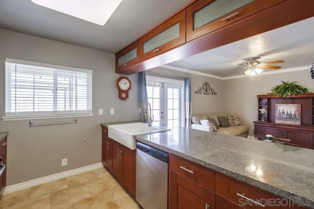 880 Friendly Circle El Cajon, CA 92021 - Photo 8 of 27 a kitchen with granite countertop a sink and a window