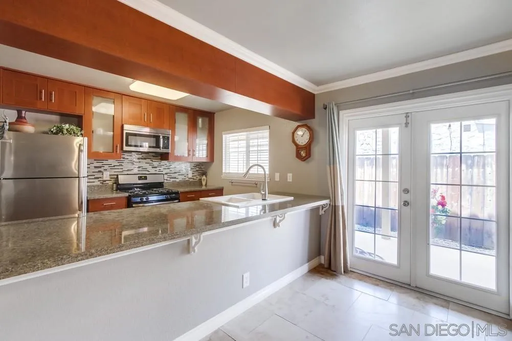880 Friendly Circle El Cajon, CA 92021 - Photo 10 of 27 a large kitchen with a large window and stainless steel appliances