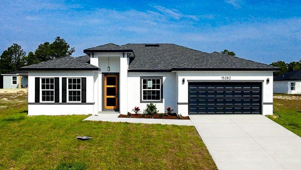15282 Southwest 65th Avenue Road Ocala, FL 34473 - Photo 1 of 33 front view of a house with a yard