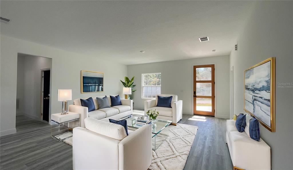 15282 Southwest 65th Avenue Road Ocala, FL 34473 - Photo 11 of 33 a living room with furniture a flat screen tv and a fireplace