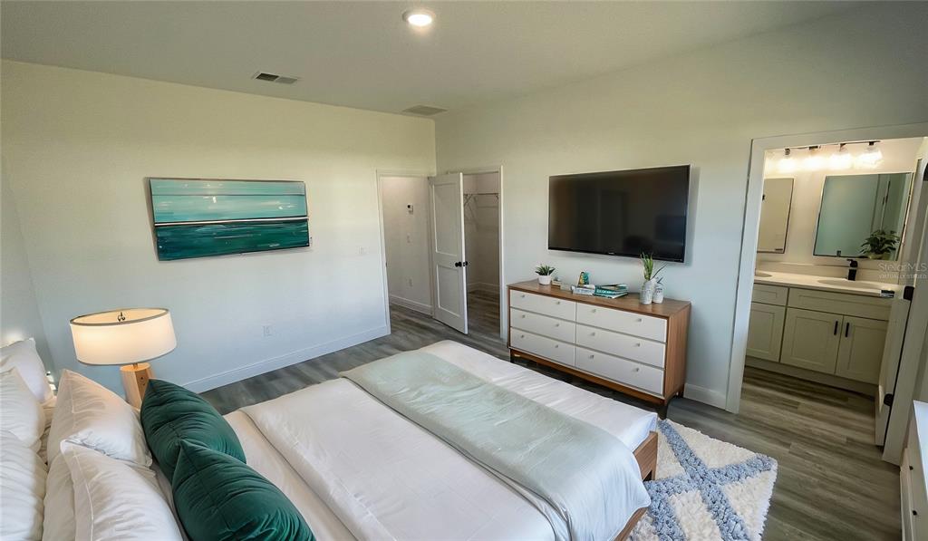 15282 Southwest 65th Avenue Road Ocala, FL 34473 - Photo 19 of 33 a bedroom with a bed and a flat screen tv