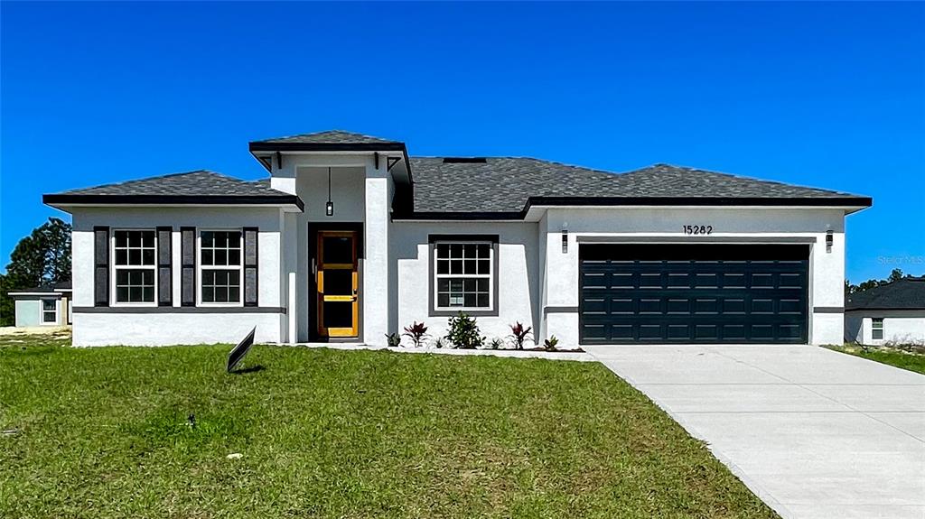 15282 Southwest 65th Avenue Road Ocala, FL 34473 - Photo 2 of 33 a front view of a house with a yard