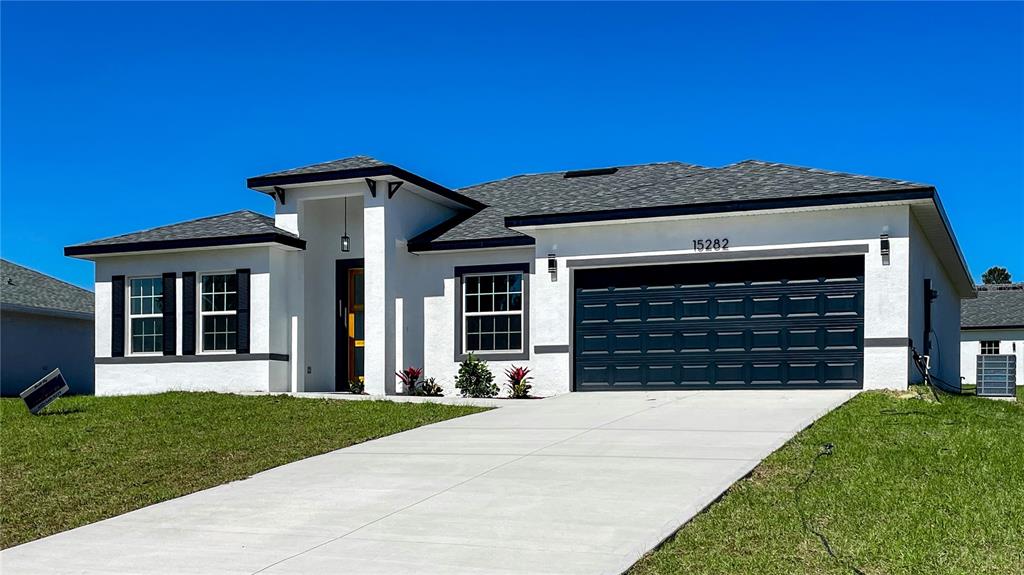 15282 Southwest 65th Avenue Road Ocala, FL 34473 - Photo 3 of 33 a front view of a house with a yard